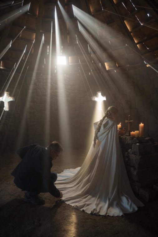 Jeremy Boreing adjusts Charis's cloak in St Joseph's shrine — Episode 3.