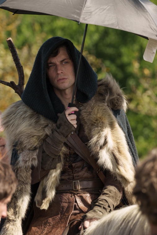 Hooded, furred, and umbrellaed between takes on the Maridunum fields — Episode 3.