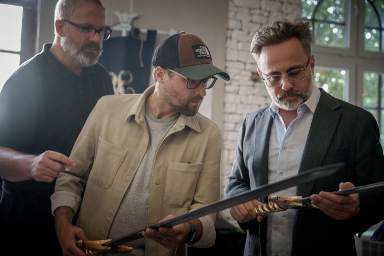 Dallas Sonnier, Ryan Whitaker, and Jeremy Boreing inspecting the hero swords with the armoury team before the shoot.