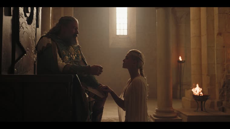 Charis (Rose Reid) kneels to her father: “Allow me to go to him freely, so that I may return freely.”