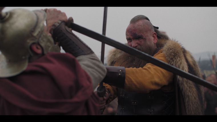“Enough, my lord. There is nothing to be gained!” Gorlas (Chick Allan) challenges a would-be king.