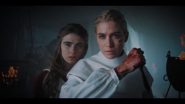 Ygerna (Flo Thompstone) and Charis (Rose Reid), blade in hand, as the battle reaches them.